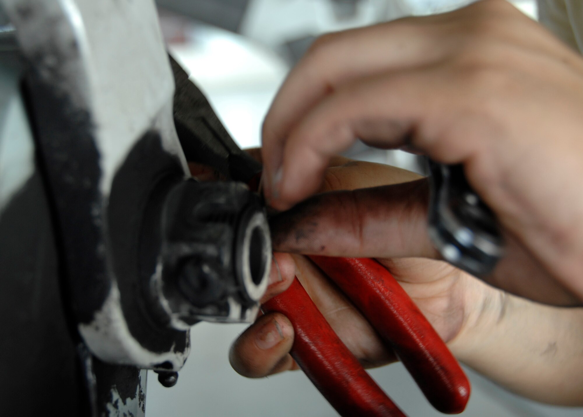 Senior Airman Marlene Roque removes the retaining bolt from a landing gear support fixture at the home station check hangar on Charleston AFB. Maintenance Airmen at the HSC hangar fully inspect an average of three C-17s a week.  Airman Roque is a crew chief with the 437th Maintenance Squadron. (U.S. Air Force photo/Airman 1st Class Katie Gieratz)