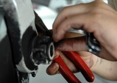 Senior Airman Marlene Roque removes the retaining bolt from a landing gear support fixture at the home station check hangar on Charleston AFB. Maintenance Airmen at the HSC hangar fully inspect an average of three C-17s a week.  Airman Roque is a crew chief with the 437th Maintenance Squadron. (U.S. Air Force photo/Airman 1st Class Katie Gieratz)
