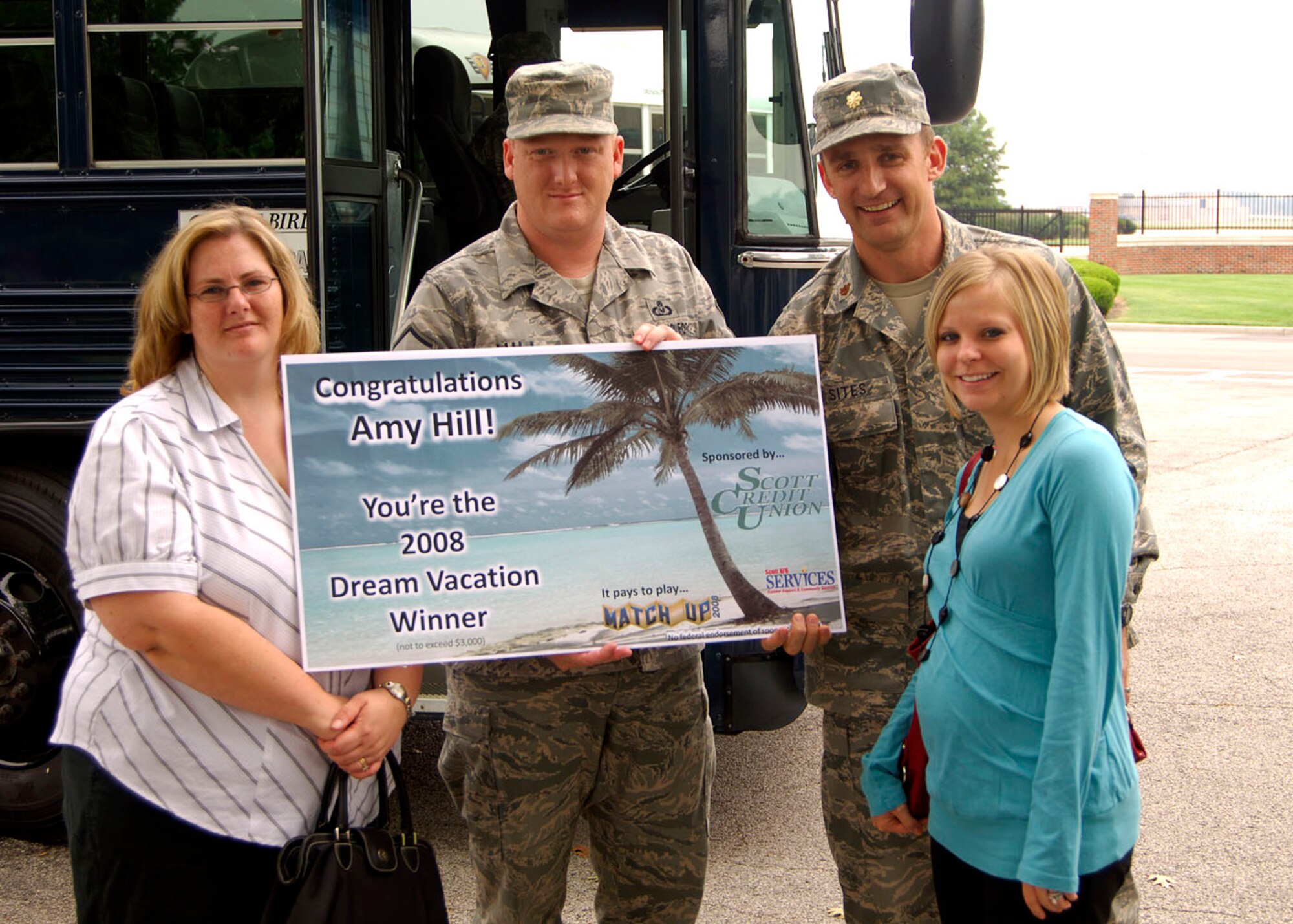 SCOTT AIR FORCE BASE, Ill. -- Maj. Tim Sites (right), 375th Services Commander and Ashleigh Deatherage (right front), Scott Credit Union Community Relations supervisor, present Amy Hill (left) and her husband Master Sgt. Kevin Hill (center), Air Mobility Command Inspector General, with a $3,000 check Sept. 11th. The Hill Family won the Match Up $3,000 Dream Vacation sponsored by Scott Credit Union. 
No federal endorsement of sponsor intended.
(US Air Force photo/Airman 1st Class Wesley Farnsworth)
