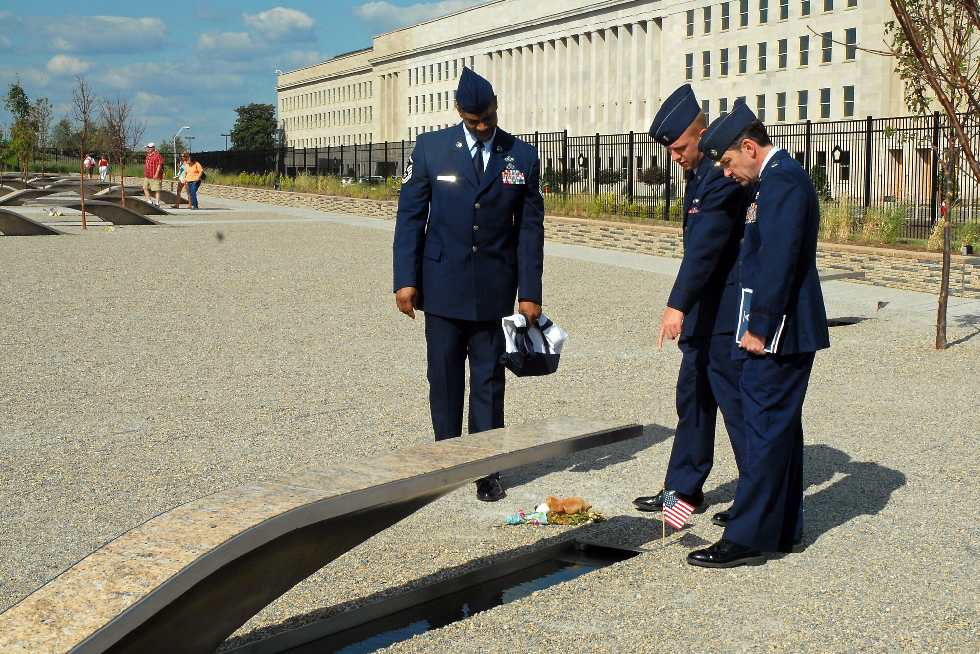 Master Sgt. Charles Washington, 2nd Lt. Justin Ellsworth and Lt. Col. Nelson Novo look at one of 184 inscribed memorial units that are part of the Pentagon Memorial in Washington, D.C., Sept. 15. Members of the 437th Airlift Wing went to D.C. to accept the Verne Orr Award and also received a tour of the Pentagon. Sergeant Washington is with the 437 AW Legal Office, Lieutenant Ellsworth is with the 437th Communications Squadron and Colonel Novo is the 437 AW director of staff. (U.S. Air Force photo/Airman 1st Class Melissa White)