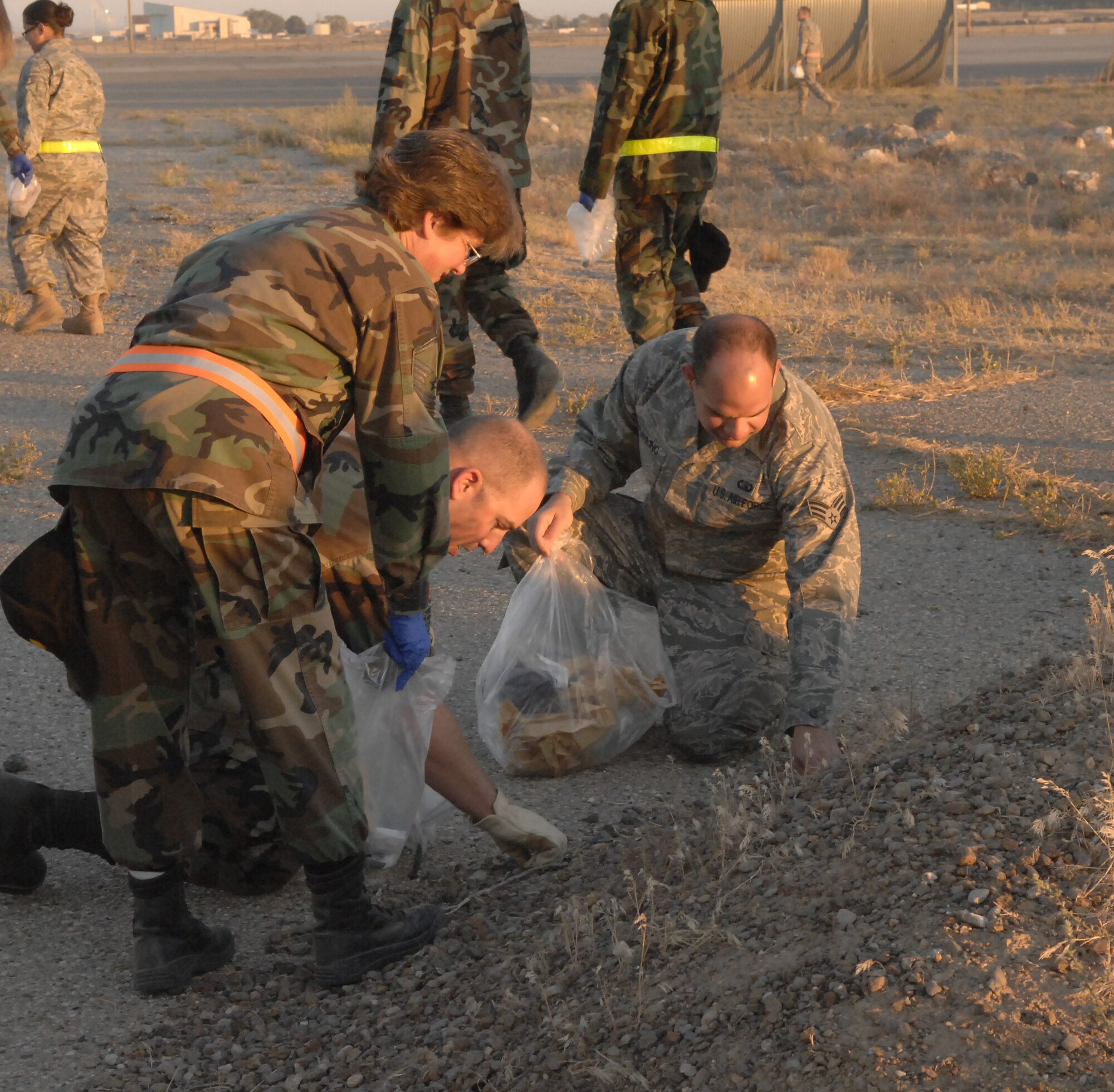 MOUNTAIN HOME AIR FORCE BASE, Idaho - Airmen pick up rounds of spent blank ammunition found on the flightline during the annual FOD walk at Mountain Home Air Force Base Sept. 15. The FOD walk was scheduled to clear the flightline of objects that were left over after the Gunfighter Skies 2008 air show held over the weekend. (U.S. Air Force photo\ Staff Sgt. Brian Stives)