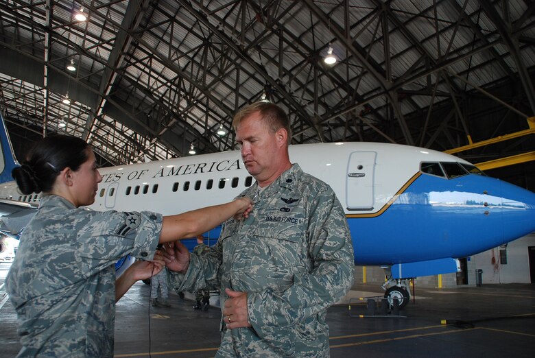Former 932nd Airlift Wing Maintenance Group commander Lt. Col. Kirk Peddicord, gets a microphone hooked up during the filming of a documentary for the Air Force Reserve Command's Illinois wing.  Behind him is a C-40C plane belonging to the wing.  (U.S. Air Force photo by Maj. Stan Paregien)