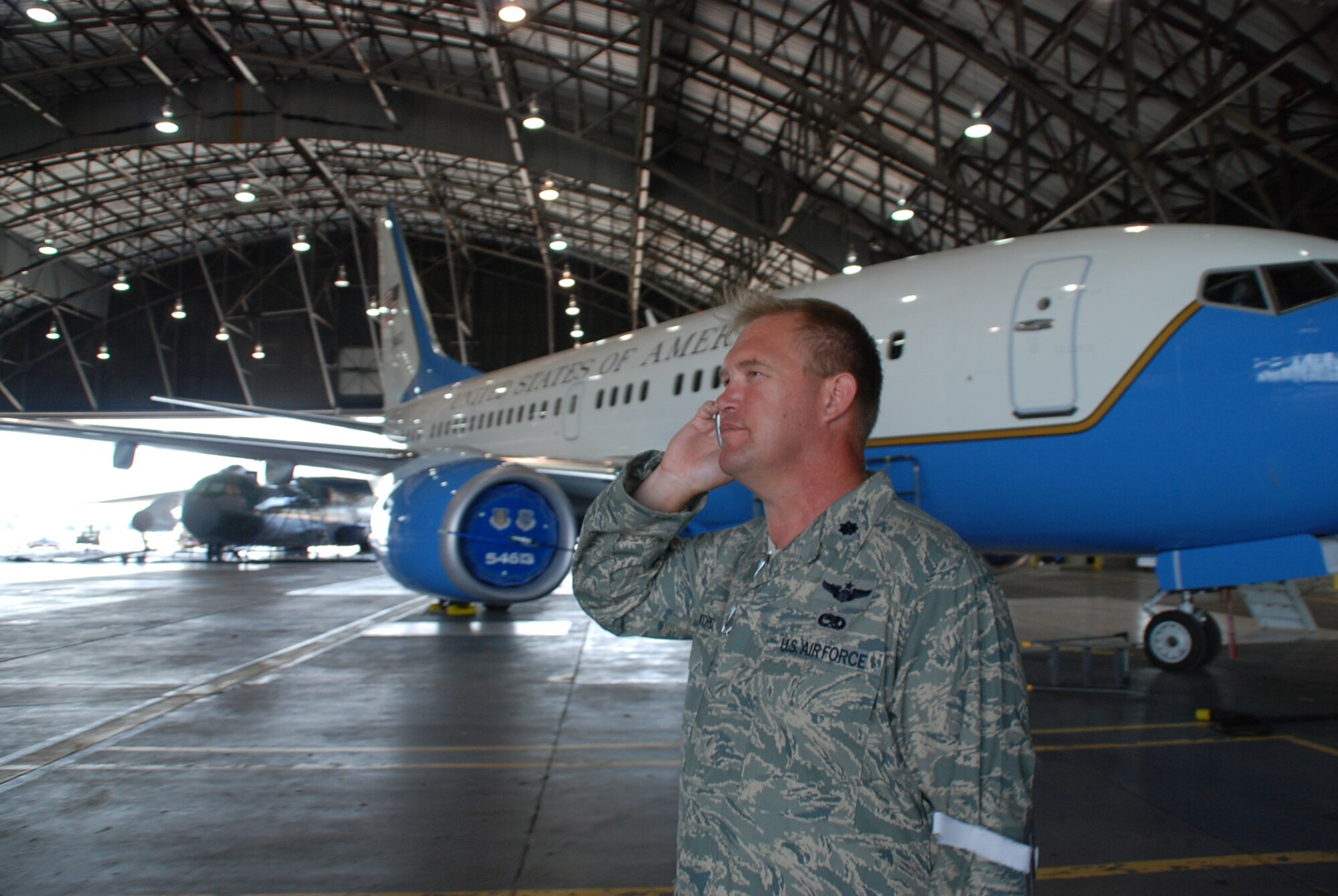 932nd Maintenance Group command Lt. Col. Kirk Peddicord takes a call as his Air Force Reservists get a plane ready recently.  (U.S. Air Force photo by Maj. Stan Paregien)