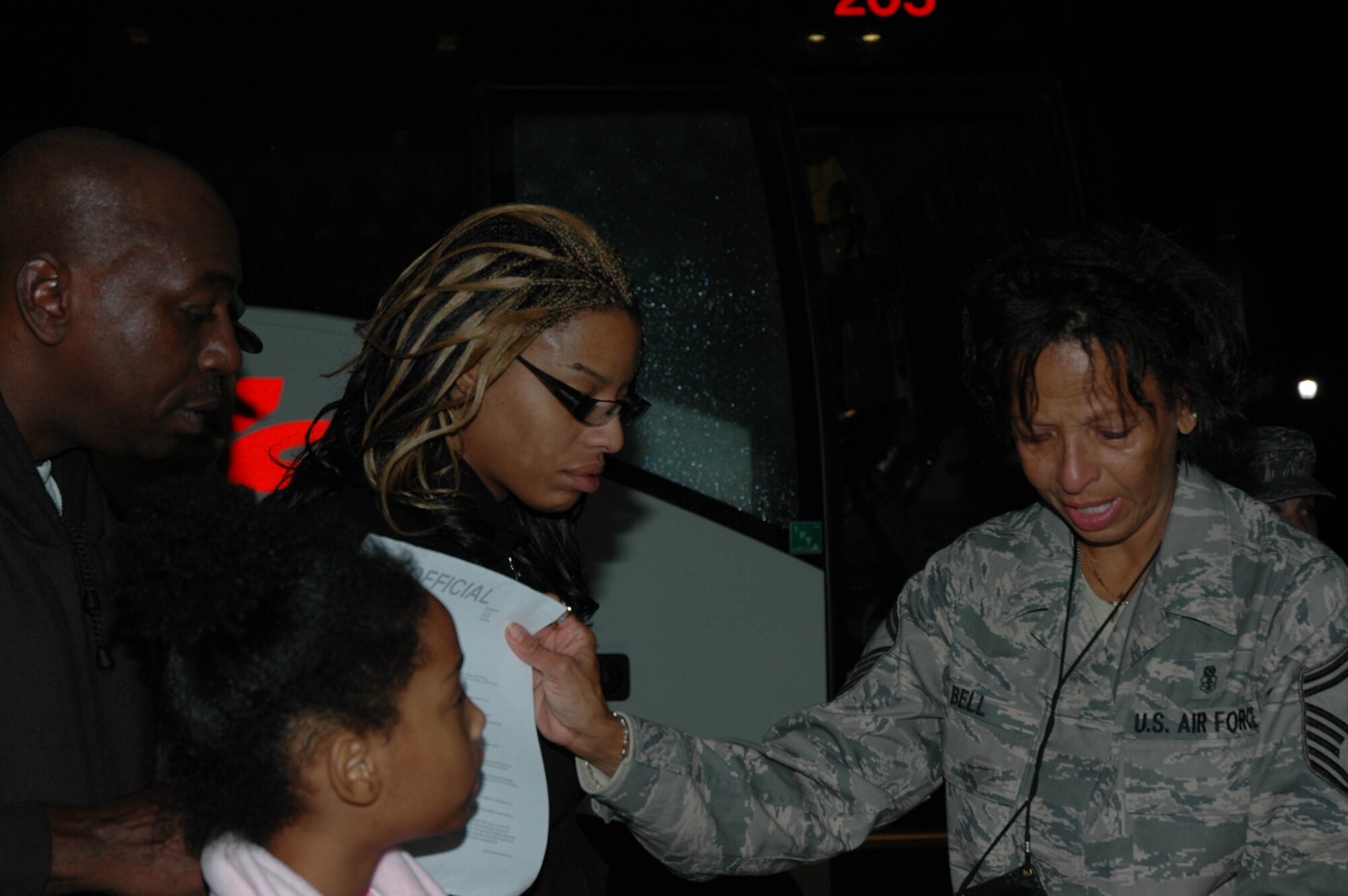 MCGUIRE AIR FORCE BASE, N.J. -- Senior Master Sgt. Claudia Bell, a medical administrator with the Reserve 514th Aeromedical Evacuation Squadron, gives her family a copy of her military orders prior to departing Saturday on a 120-day deployment to Iraq. This fall about 50 Citizen Airmen from McGuire AFB are scheduled to participate in four-month deployments supporting the Global War on Terrorism. (U.S. Air Force photo/Master Sgt. Donna T. Jeffries)