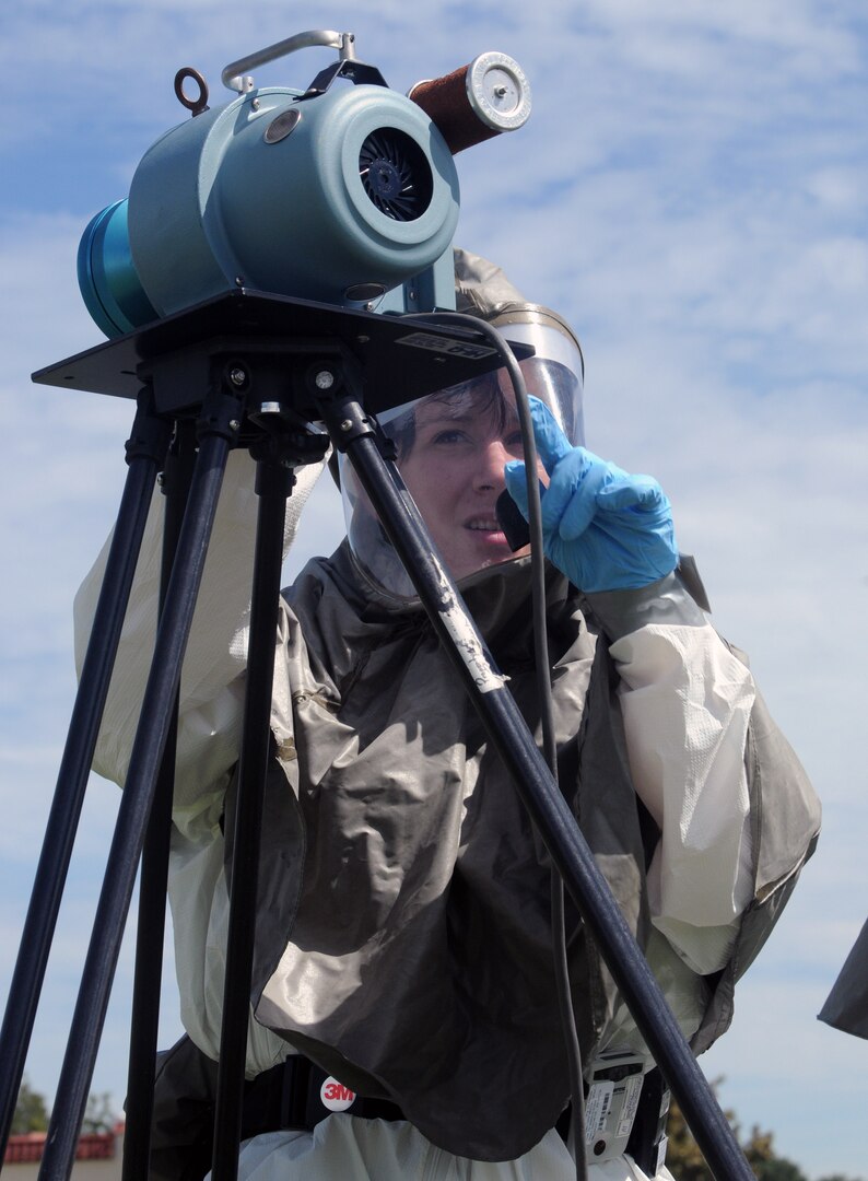 A bioenvironmental engineer takes air samples during an exercise to determine airborne hazards after a simulated bomb exploded near the fitness center Sept. 16. On the heels of supporting the search and rescue mission for Hurricane Ike, Team Randolph members continued to demonstrate their level of readiness and attention to detail while conducting an explosion and hazardous materials exercise. (U.S. Air Force photo by Steve White.)