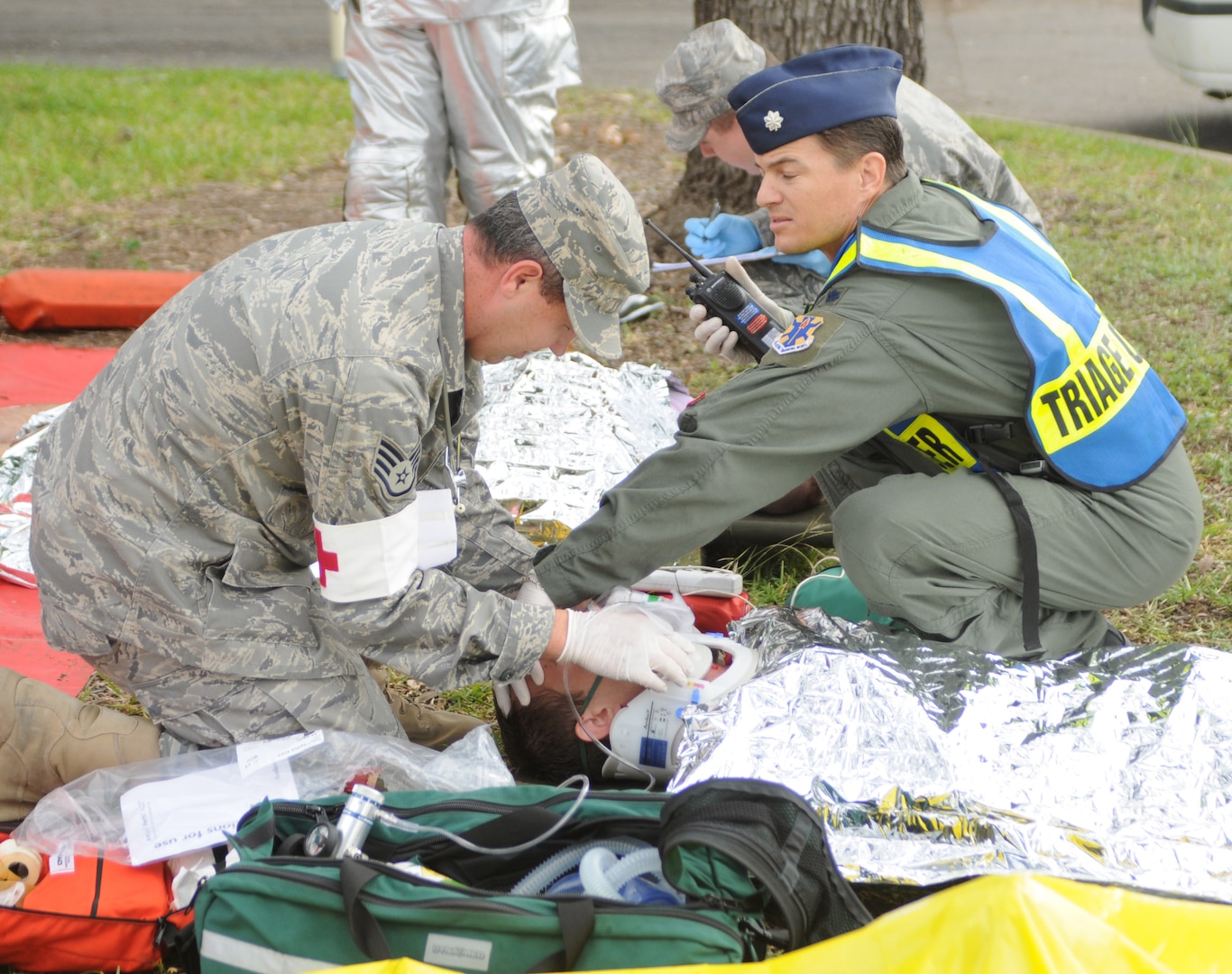 A medic performs triage on a patient after a simulated explosion kicked off an exercise Sept. 16. On the heels of supporting the search and rescue mission for Hurricane Ike, Team Randolph members continued to demonstrate their level of readiness and attention to detail while conducting an explosion and hazardous materials exercise. (U.S. Air Force photo by Steve White.)