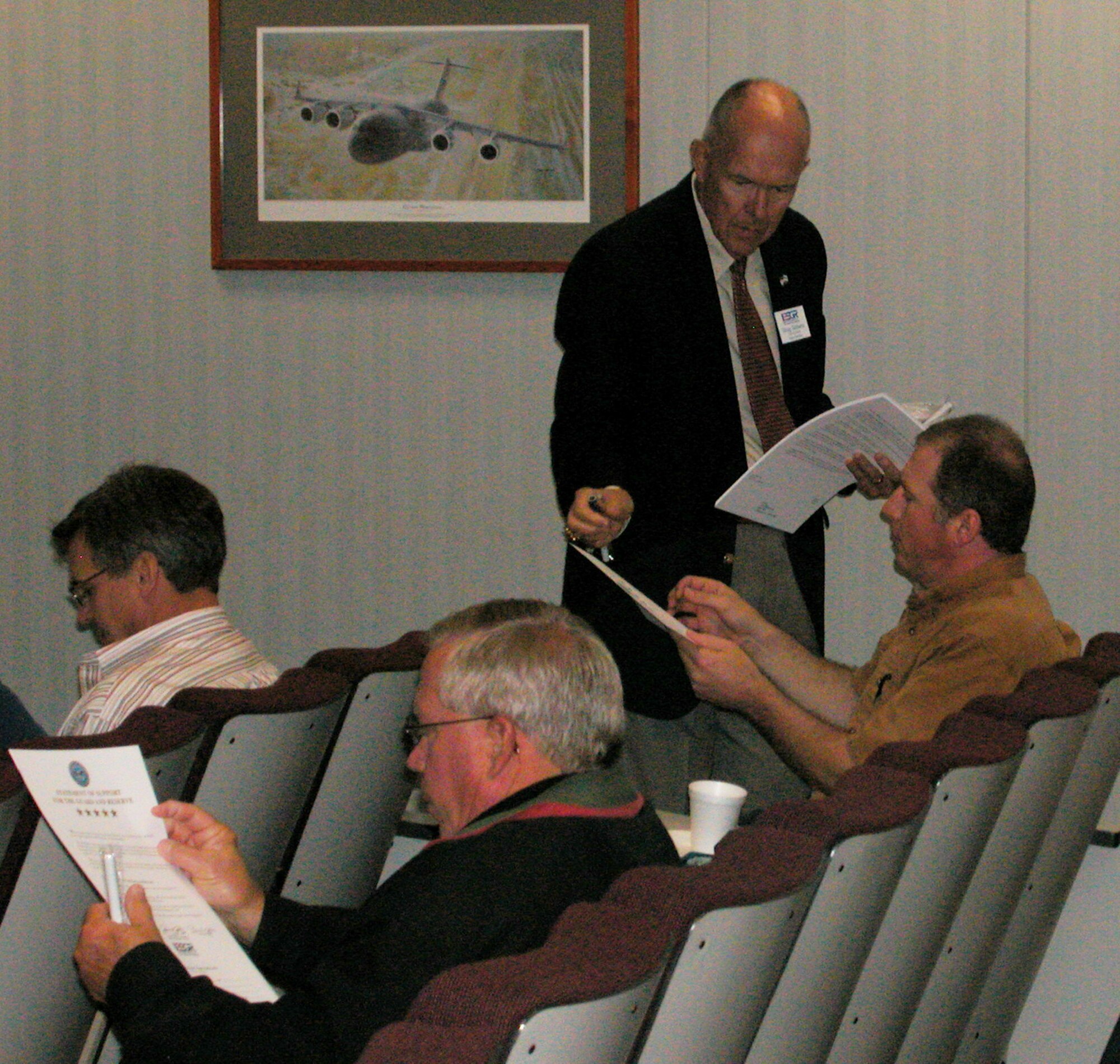 GRISSOM AIR RESERVE BASE, Ind., -- Doug Gibbens (standing), executive director of the Indiana Committee for Employer Support of the Guard and Reserve, distributes "Five Star" Statements of Support to participants of an employer orientation flight at Grissom.  The civilian employers of Air Force Reserve personnel took part in a flight aboard a KC-135R Stratotanker, executive session with Brig. Gen. Dean Despinoy, 434th Air Refueling Wing commander, and ESGR briefing to increase their awareness of Grissom's mission.  (U.S. Air Force photo/Lt Col Gary Lockard)        