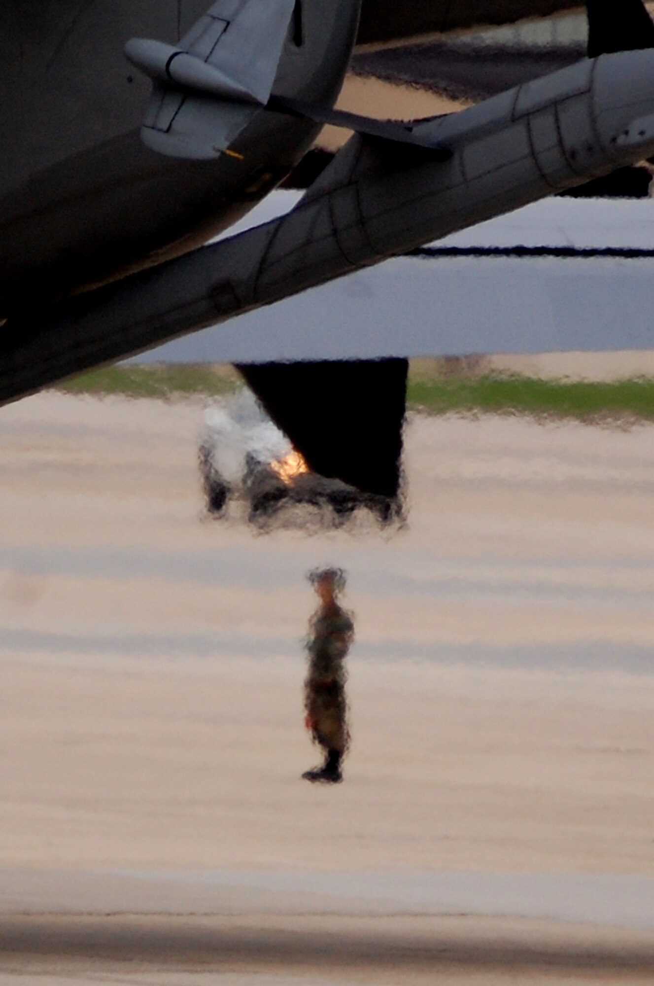 A maintenance crew chief for a KC-10 Extender is blurred by exhaust as he watches as a KC-10 fires up its engines prior to a mission at McGuire Air Force Base, N.J., Sept. 16, 2008.  The KC-10 is one of the main air refueling aircraft at McGuire which help Air Mobility Command and the Air Force to "fly, fight and win...in air, space and cyberspace."  (U.S. Air Force Photo/Tech. Sgt. Scott T. Sturkol)