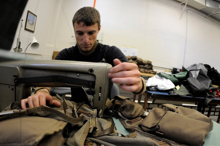BARKSDALE AIR FORCE BASE, La- Senior Airman Nick Miles repairs a survival vest at the parachute shop, here, September 16. Repacking parachutes is not the only function performed by the shop, they also repair the parachutes and other survival gear. (U.S. Air Force photo by Airman 1st Class Joanna M. Kresge)