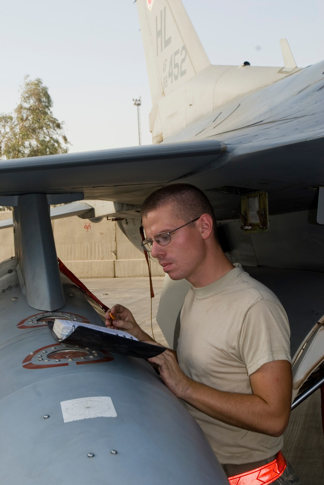 Airman 1st Class Jeremy Meyers conducts a through flight inspection on an F-16 Fighting Falcon at Joint Base Balad, Iraq, Sept. 12. A through flight inspection allows maintainers to thoroughly prepare an aircraft for its next mission within a few hours. Meyers, an F-16 tactical aircraft maintenance apprentice with the 332nd Expeditionary Aircraft Maintenance Squadron here, is deployed from Hill Air Force Base, Utah. His hometown is Spokane, Wash. (U.S. Air Force photo/Tech. Sgt. Erik Gudmundson)