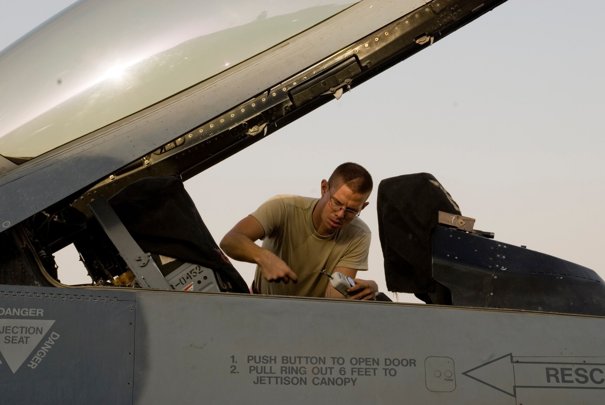 Airman 1st Class Jeremy Meyers conducts a through flight inspection on an F-16 Fighting Falcon at Joint Base Balad, Iraq, Sept. 12. A through flight inspection allows maintainers to thoroughly prepare an aircraft for its next mission within a few hours. Meyers, an F-16 tactical aircraft maintenance apprentice with the 332nd Expeditionary Aircraft Maintenance Squadron here, is deployed from Hill Air Force Base, Utah. His hometown is Spokane, Wash. (U.S. Air Force photo/Tech. Sgt. Erik Gudmundson)