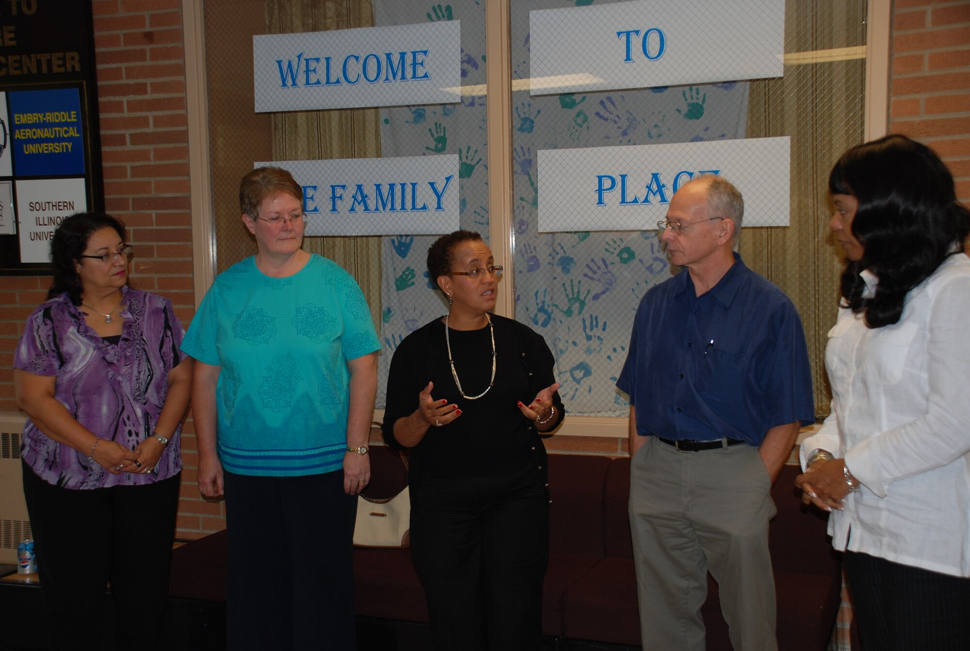 Center, Melodye Giovanni, Family Advocacy Program manager, speaks to guests during the Family Place open house at the former Challenger Elementary School Sept. 12. Ms. Giovanni gave the guest a tour of the facility, which can be used by military members and families to conduct meetings, social gatherings and more. To reserve a space at Family Place, call Family Advocacy at (609) 754-9680. (U.S. Air Force photo/Airman 1st Class Bekah Phy)