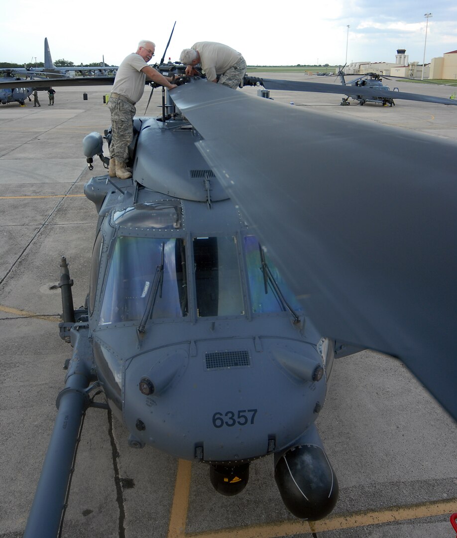 Tech. Sgts. William Gulledge (left) and Gary Vaughn, both 943rd Maintenance Squadron from Davis-Monthan Air Force Base, Ariz., perform maintenance on an HH-60 helicopter on the Randolph flightline Sept. 14 in preparation for search and rescue missions from Hurricane Ike. (U.S. Air Force photo by Steve White)