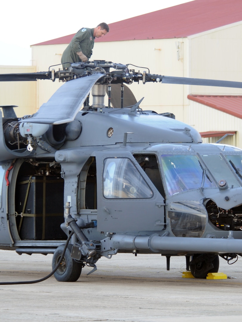 An Airmen inspects maintenance performed on an HH-60 helicopter on the Randolph flightline Sept. 14. Airmen from across the United States prepared for search and rescue missions last week as Hurricane Ike approached the Texas coastline. (U.S. Air Force photo by Steve White)