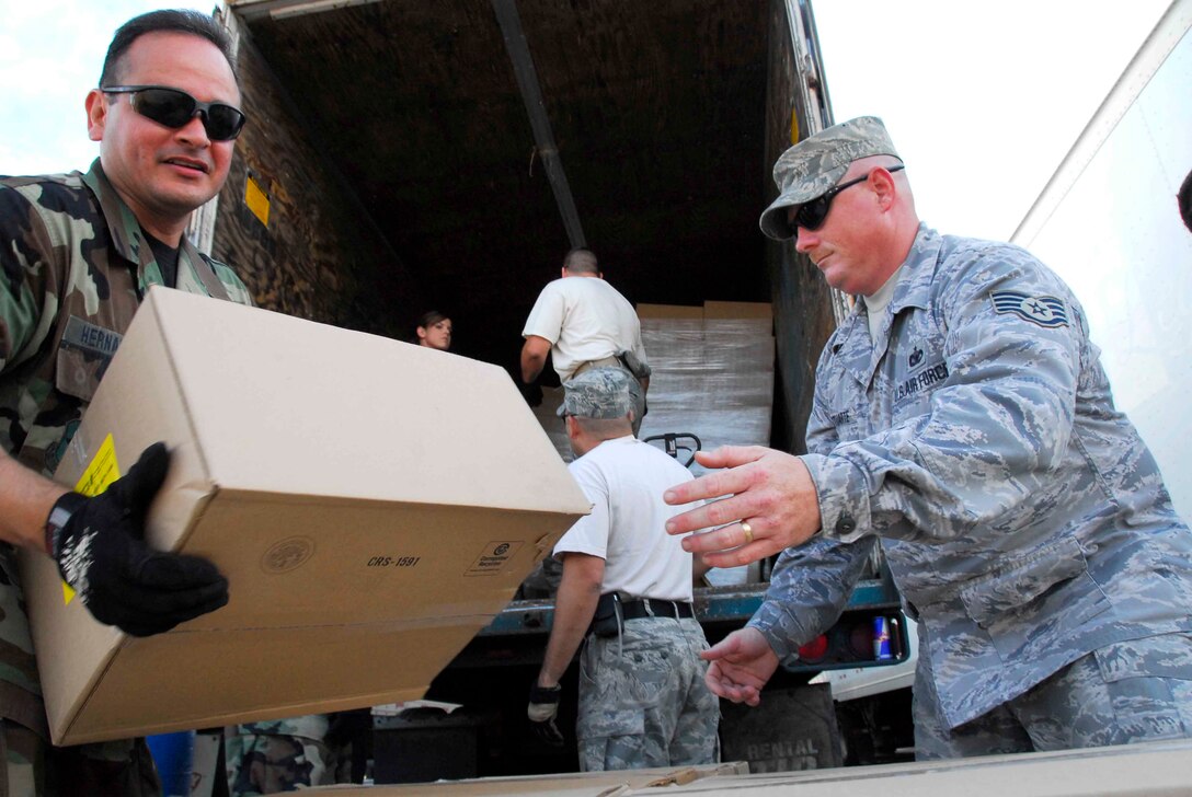 Members of the Texas Air National Guard's 149 Fighter Wing unload a trailer at a Point of Distribution (POD), Dickinson, Texas.  PODs have been set up across the path of Hurricane Ike to distribute food, water and ice to residents in the aftermath of the hurricane.(U.S. Air Force photo Master Sgt. Robert Shelley)