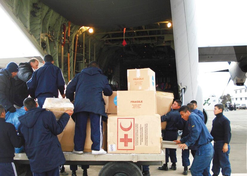 Peruvian Air Force personnel unload Red Cross and Red Crescent supplies from a Maryland National Guard C-130J during the earthquake relief efforts in Pisco Peru Aug 2007.  An example of what SICOFAA's Cooperation I exercise will be simulating.  (USAF photo by Col. William A. Stark)