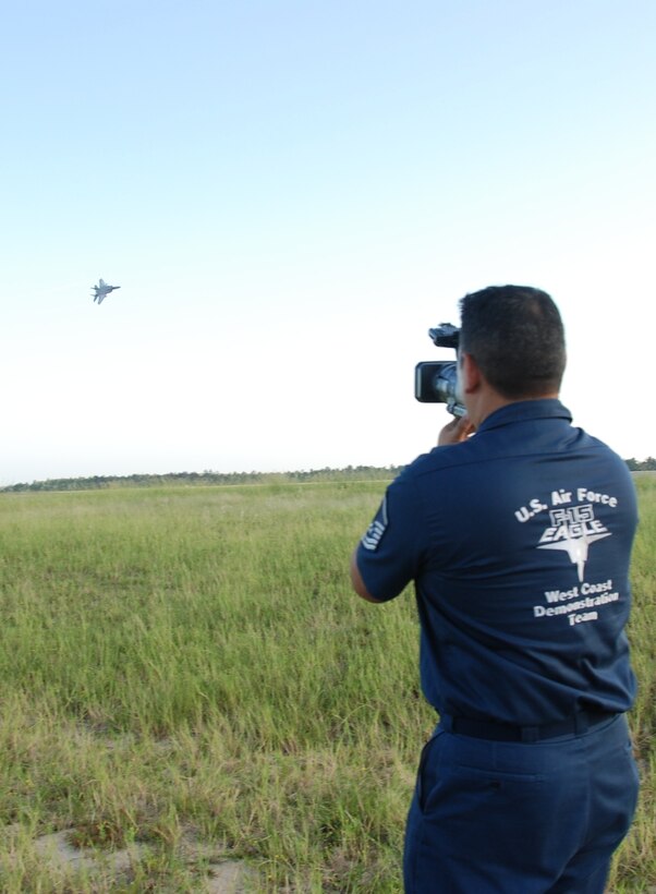 Master Sgt. Peter Williams, F-15 West Coast Demo Team’s Lead Production Superintendent, videotapes Capt. Sam Joplin’s F-15 practice demonstration at Eglin AFB Fla., Sept. 15. Every practice and performance is recorded and then critiqued by the team for timing and maneuver improvements. The F-15 West Coast Demo Team is assigned to the 33d Fighter Wing and performs 33 shows per year. The F-15 West Coast Demo Team is one of six single aircraft demonstration teams assigned to Air Combat Command. The F-15 West Team originated from Holloman AFB, N.M., then moved to Tyndall AFB, Fla., and finally settled at Eglin in the early 1990's. The name "West Coast" has been retained for heritage purposes. (U.S. Air Force Photo/Capt. Carrie Kessler)