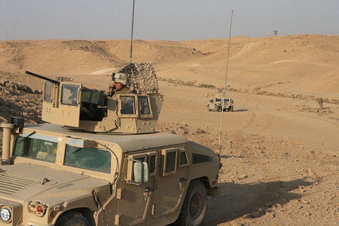 Lance Cpl. Gravin Guillen, an infantryman with Company F, 2nd Battalion, 25th Marine Regiment, monitors radio communications and mans a .50mm machine gun during a security patrol outside of Al Asad Air Base, Iraq, Sept. 17. Marines and sailors with Company F are attached to Security Bn., 3rd Marine Aircraft Wing (Forward) and recently replaced an element of Marine Wing Support Squadron 274. The company is now solely responsible for the base’s external security.