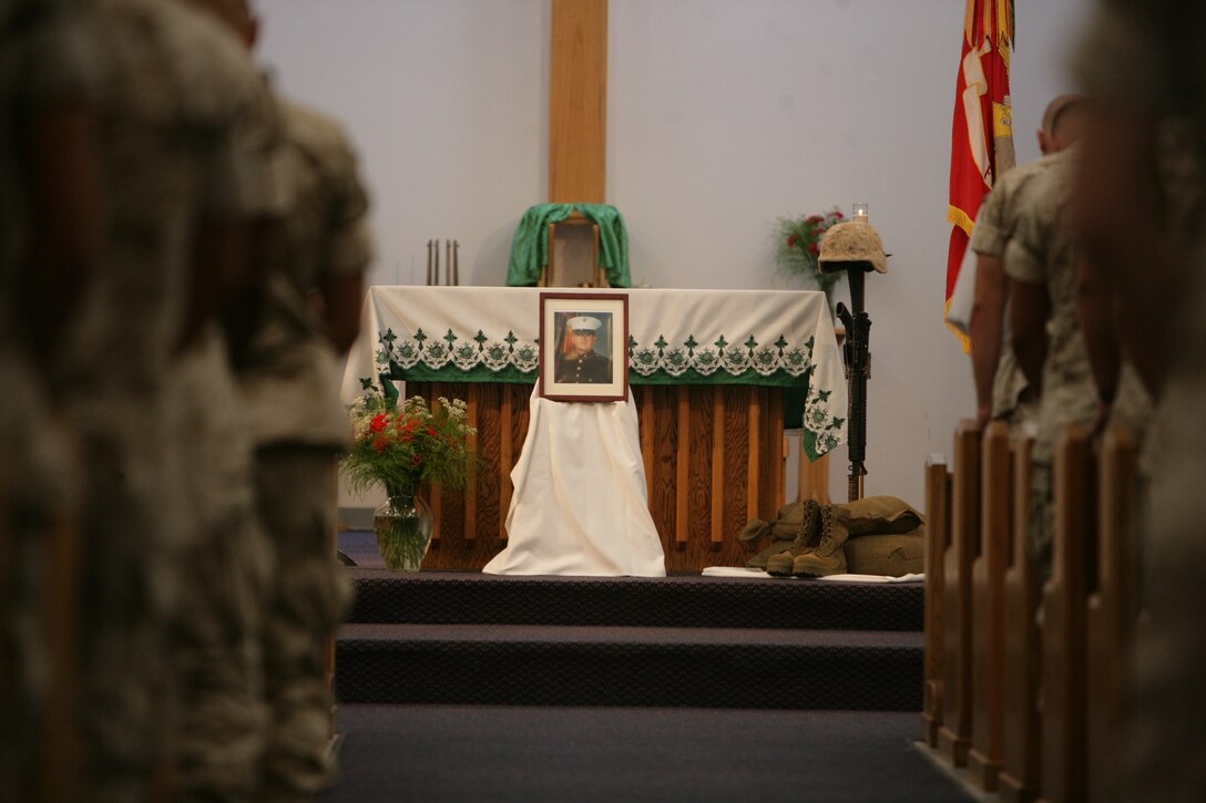 Marines stand in honor of Pfc. Ernie Villarreal, infantry weapons repairman and an El Paso, Texas, native, during a memorial service Sept. 18 at the Combat Center’s Catholic Chapel who died Sept. 16 at Robert E. Bush Naval Hospital. He is survived by his wife, Wendy and his three children Haley, Maverick and Makayla.