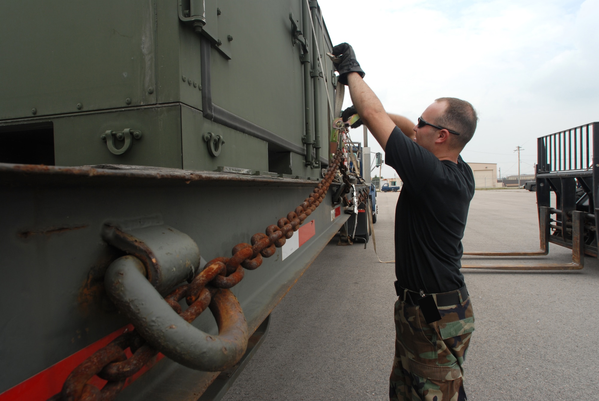 KUNSAN AIR BASE, Republic Of Korea -- Airman 1st Class Nathan Dunlap, 8th logistics Readiness Squadron, unhooks cargo pallets on a truck here Sept. 11. The cargo pallets are being sent with Airmen of the 8th Fighter Wing to Red Flag-Alaska.(US Air Force Photo By: Angela Ruiz)