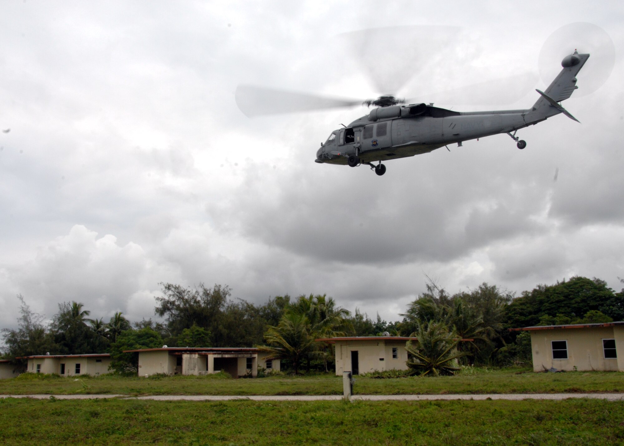 ANDERSEN AIR FORCE BASE, Guam - A MH-60S Knighthawk from the U.S. Navy Helicopter Sea Combat Squadron 25, flies over Andersen South Sept. 17. The U.S. Navy members worked in conjunction with the Royal Australian Navy to perform a simulated fast rope scenario during TRICRAB '08. The joint-service explosive ordnance disposal training focuses on individual battle drills, reaction to direct and indirect fire, communication skills, tactical convey operations and improvised explosive devices. (U.S. Air Force photo by Airman 1st Class Nichelle Griffiths)
