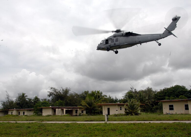ANDERSEN AIR FORCE BASE, Guam - A MH-60S Knighthawk from the U.S. Navy Helicopter Sea Combat Squadron 25, flies over Andersen South Sept. 17. The U.S. Navy members worked in conjunction with the Royal Australian Navy to perform a simulated fast rope scenario during TRICRAB '08. The joint-service explosive ordnance disposal training focuses on individual battle drills, reaction to direct and indirect fire, communication skills, tactical convey operations and improvised explosive devices. (U.S. Air Force photo by Airman 1st Class Nichelle Griffiths)
