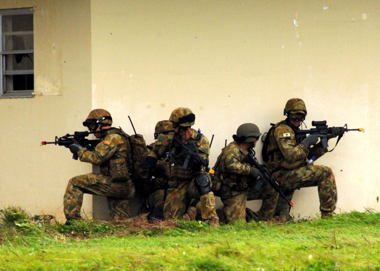 ANDERSEN AIR FORCE BASE, Guam - The Royal Australian Navy takes a defensive fighting position while clearing the outer perimeter of the building during one of many training scenarios as apart of TRICRAB '08 Sept. 17 at Andersen South.  The biannual training exercise employs realistic scenarios designed to hone interoperability among U.S., Australian, and Singapore EOD forces. (U.S. Air Force photo by Airman 1st Class Nichelle Griffiths)