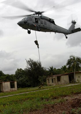 ANDERSEN AIR FORCE BASE, Guam- The Royal Australian Navy participates in a simulated fast rope scenario with the U.S. Navy, Helicopter Sea Combat Squadron, MH-60S Kinghthawk helicopter Sept. 17 at Andersen South. The scenario was one of many that took place during TRICRAB '08. Teams representing the U.S. Air Force, U.S. Navy, U.S. Army National Guard Guam, Royal Australian Air Force and Royal Australian Navy took part in this four day field exercise. (U.S. Air Force photo by Airman 1st Class Nichelle Griffiths)