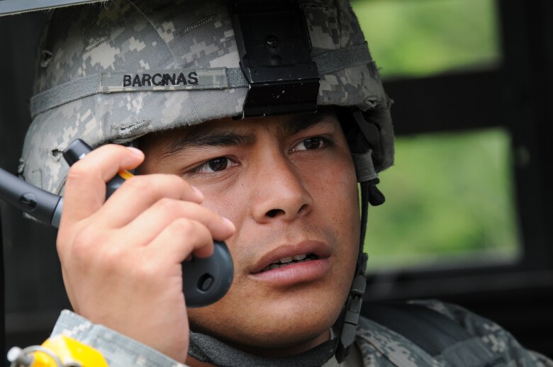 ANDERSEN AIR FORCE BASE, Guam - Sergeant Eric Barcinas from the U.S. Army National Guard Guam, relays intelligence while performing convoy security during the joint-service explosive ordnance disposal training here Sept. 17. The training, known as TRICRAB, is a biannual training exercise that employs realistic scenarios designed to hone interoperability among U.S., Australian and Singapore EOD forces. (U.S. Air Force photo by Airman 1st Class Nichelle Griffiths)