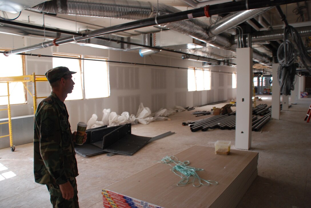 Master Sgt. John Sauerwein surveys the construction project inside the 932nd Airlift Wing's headquarters building near Cardinal Creek at Scott Air Force Base, Ill.  (U.S. Air Force photo by Maj. Stan Paregien)