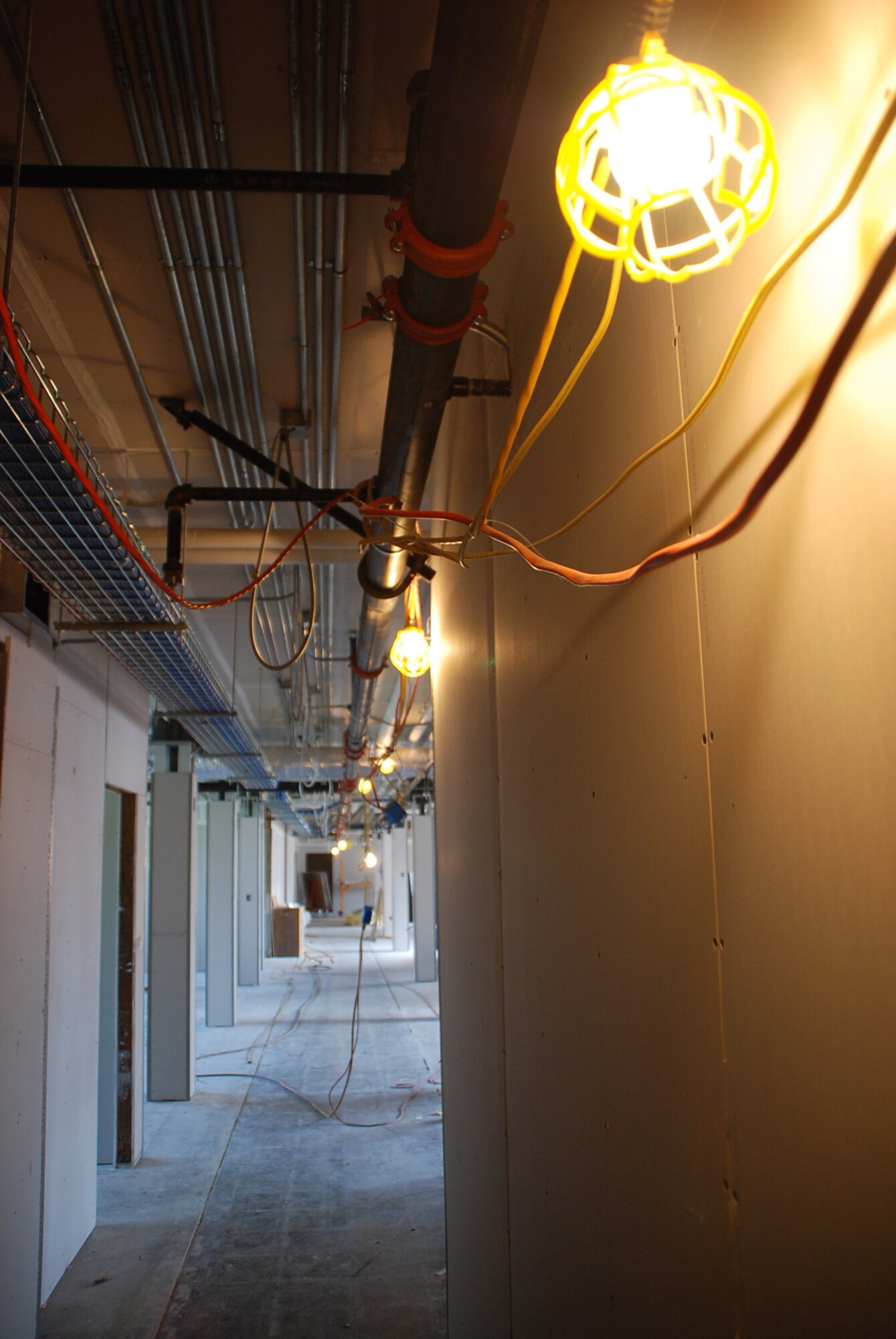 Pipes and wiring go down the hall inside the headquarters building of the 932nd Airlift Wing.  "Under construction" and "work zone" describe it best until sometime in 2009 when it should be finished.  (U.S. Air Force photo by Tech. Sgt. Gerald Sonnenberg)