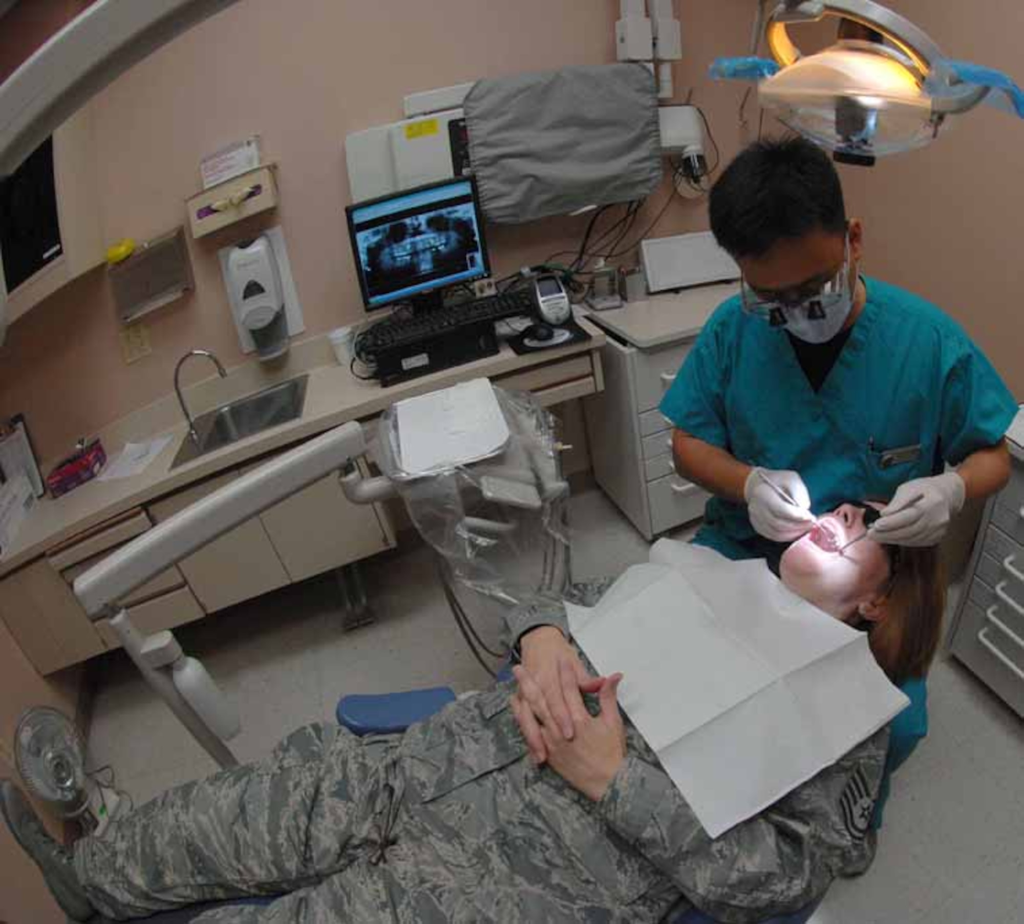 Maj. Lance Kim, a general dentist assigned to the 926th Aerospace Medicine Flight, conducts a routine dental exam on Technical Sgt. Susan O'Neal, 926th Mission Support Squadron logistics planner Aug. 22, 2008 at Nellis Air Force Base, Nev. The 926th Group is an Air Force Reserve unit under the 10th Air Force, Naval Air Station Joint Reserve Base, Fort Worth, Texas. The group is located at Nellis AFB as an associate unit to the United States Air Force Warfare Center. Through Total Force Integration, reservists are integrated into regular Air Force units, accomplishing the USAFWC's mission alongside REGAF personnel on a daily basis.
(U.S. Air Force Photo/Senior Airman Larry E. Reid Jr.)