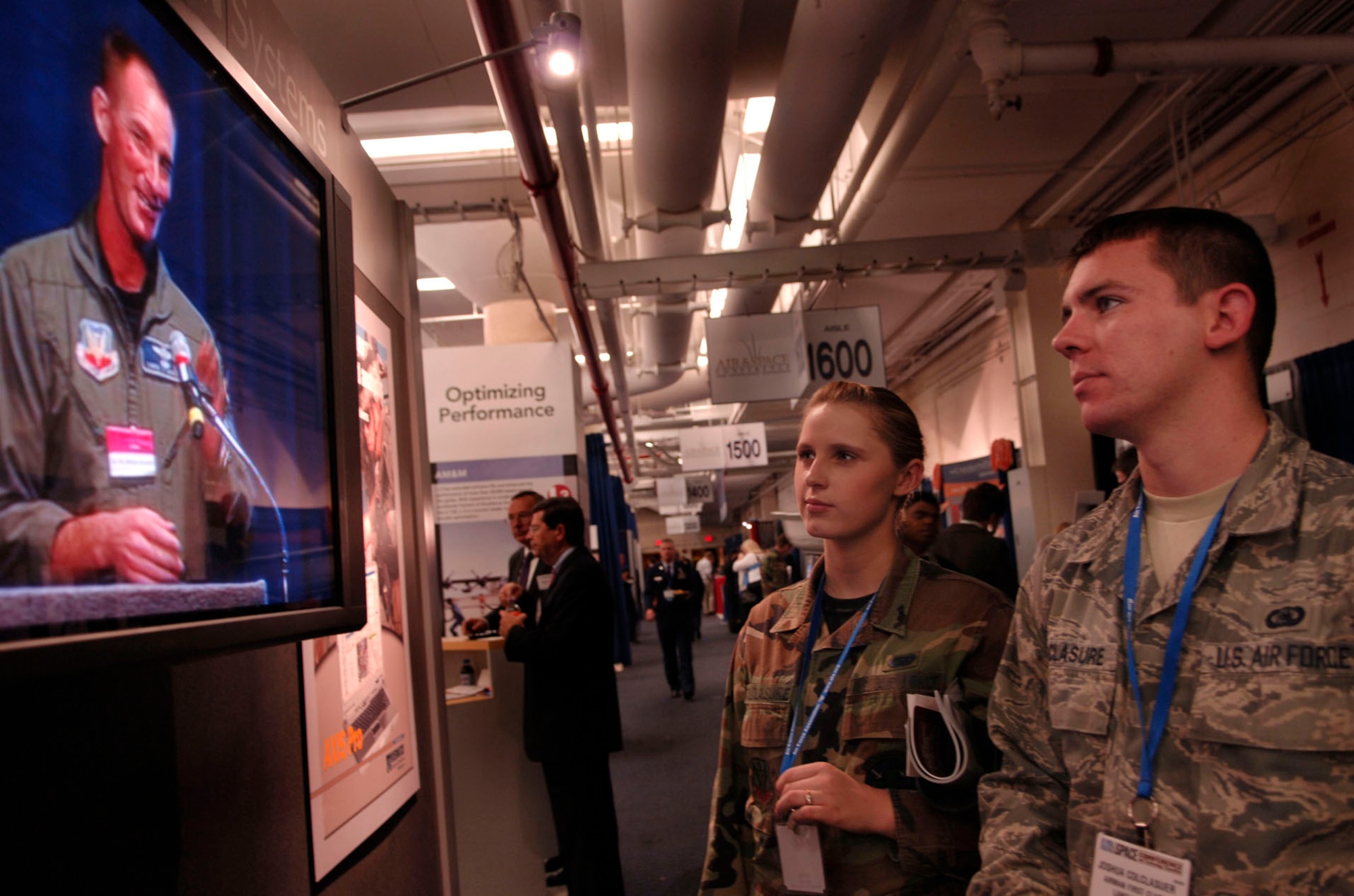 WASHINGTON -- Airmen 1st Class Erin and Joshua Colclasure watch a video on display at the Air Force Association’s 24th Annual Air and Space Conference and Technology Exposition Sept. 16. A hundred and twenty-five Langley Airmen attended the event. (U.S. Air Force photo/Airman Rebecca Montez)
