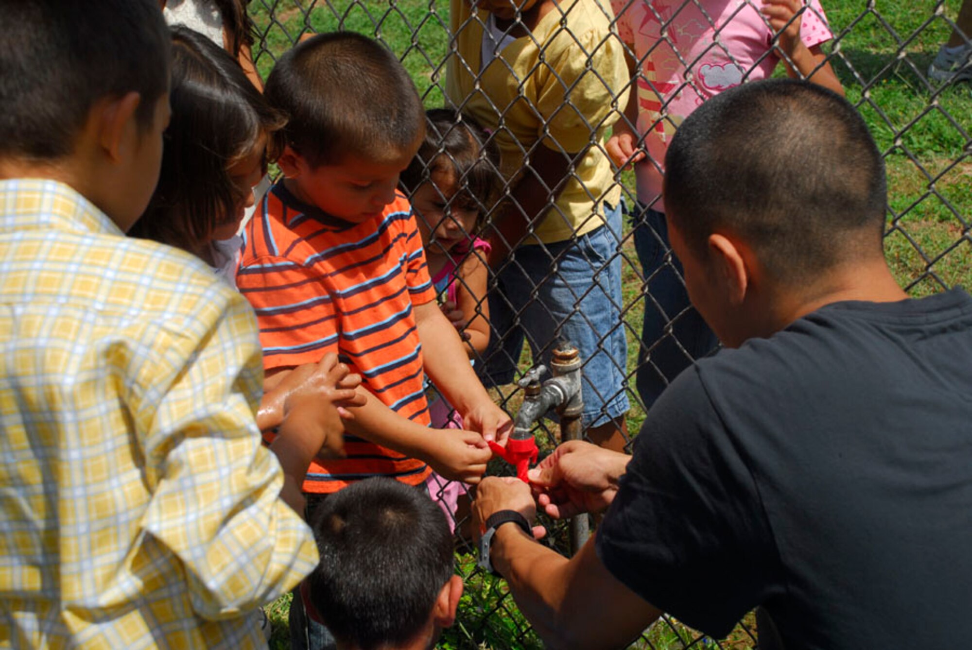 SOTO CANO AIR BASE, Honduras - Children from the Hogar de Ninos de Nuestra Senora Guadalupe orphanage create water balloons Sept. 12 here. The event held here was to celebrate Honduras Children Day. (U.S. Air Force photo by Staff Sgt. Joel Mease)