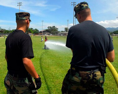 SOTO CANO AIR BASE, Honduras - Firefighters from the 612 Air Base Squadron let kids from the Hogar de Ninos de Nuestra Senora Guadalupe orphanage play in water from the fire truck Sept. 12 here. The event held here was to celebrate Honduras Children Day. (U.S. Air Force photo by Staff Sgt. Joel Mease)