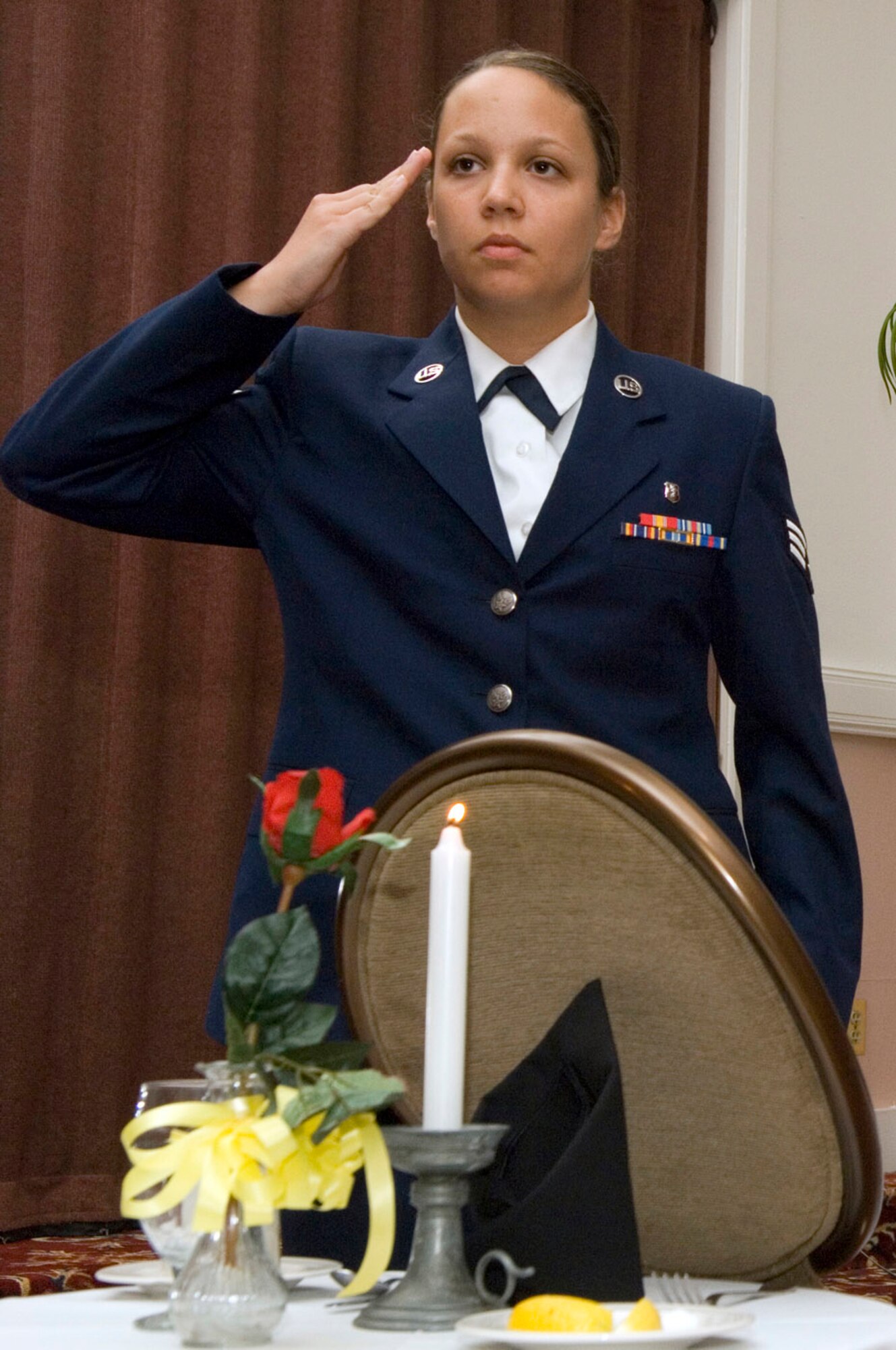 They are unable to be with their loved ones and families tonight, so we join together to pay our humble tribute to them, and bear witness to their continued absence. Let us remember and never forget their sacrifices. May God forever watch over them and protect them and their families.

Senior Airman Amanda Carter, 66th Medical Operations Squadron dental technician at Hanscom Air Force Base, Mass., leads a ceremony honoring prisoners of war and servicemembers missing in action. Such ceremonies are held before many official base events to honor and remember fallen comrades. National POW/MIA Day is Sept. 19. (U.S. Air Force photo/Mark Wyatt)