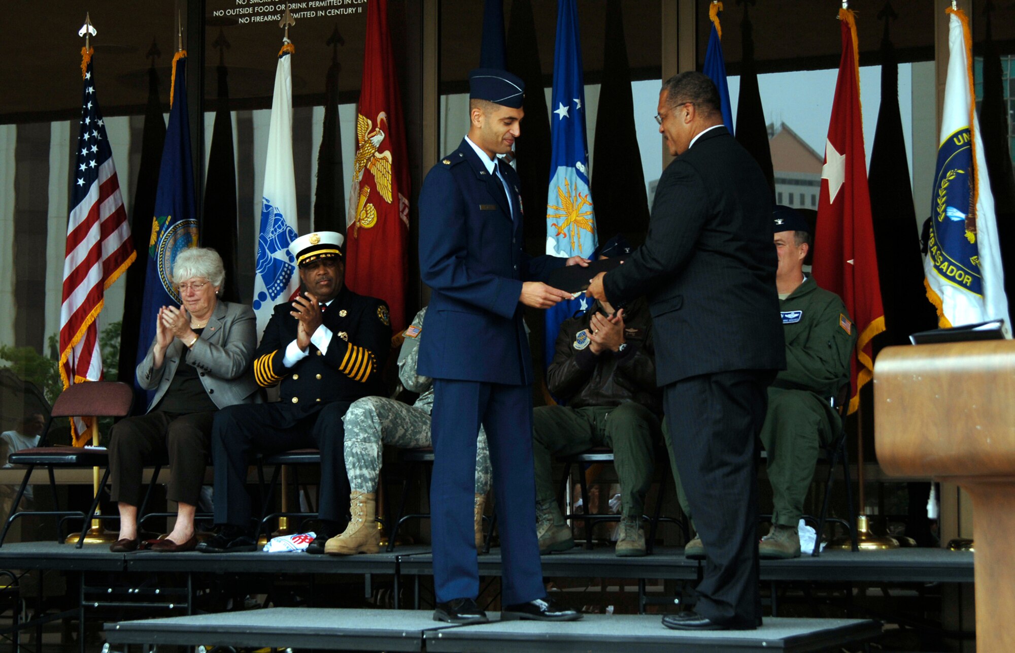 MCCONNELL AIR FORCE BASE, Kan. -- The Honorable Carl Brewer, Wichita’s Mayor, awards Maj. Paul Silas, 22nd Civil Engineer Squadron operations flight commander, a  during the first Wichita “America Supports You” Freedom Walk closing comments, Sept. 12. Major Silas was recognized for his performance as a truck commander when his team was ambushed by small-arms fire and rocket-propelled grenades in Afghanistan, from September 2007 through April 2008.  (Photo by Staff Sgt. Ronald Lafosse)