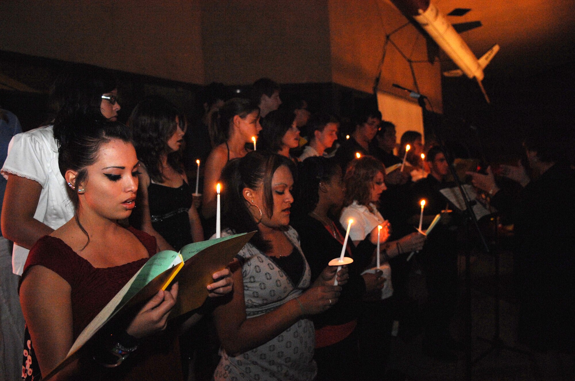 The Alamogordo High School Chorus sings ?Proud to be an American? during the candle-lighting at the seventh annual 9/11 Memorial Ceremony at the New Mexico Museum of Space History, September 11. The event was put together by the Fire Department of Holloman Air Force Base, N.M., and the Otero County Firefighters Assocation. (U.S. Air Force photo/Airman Sondra M. Escutia)