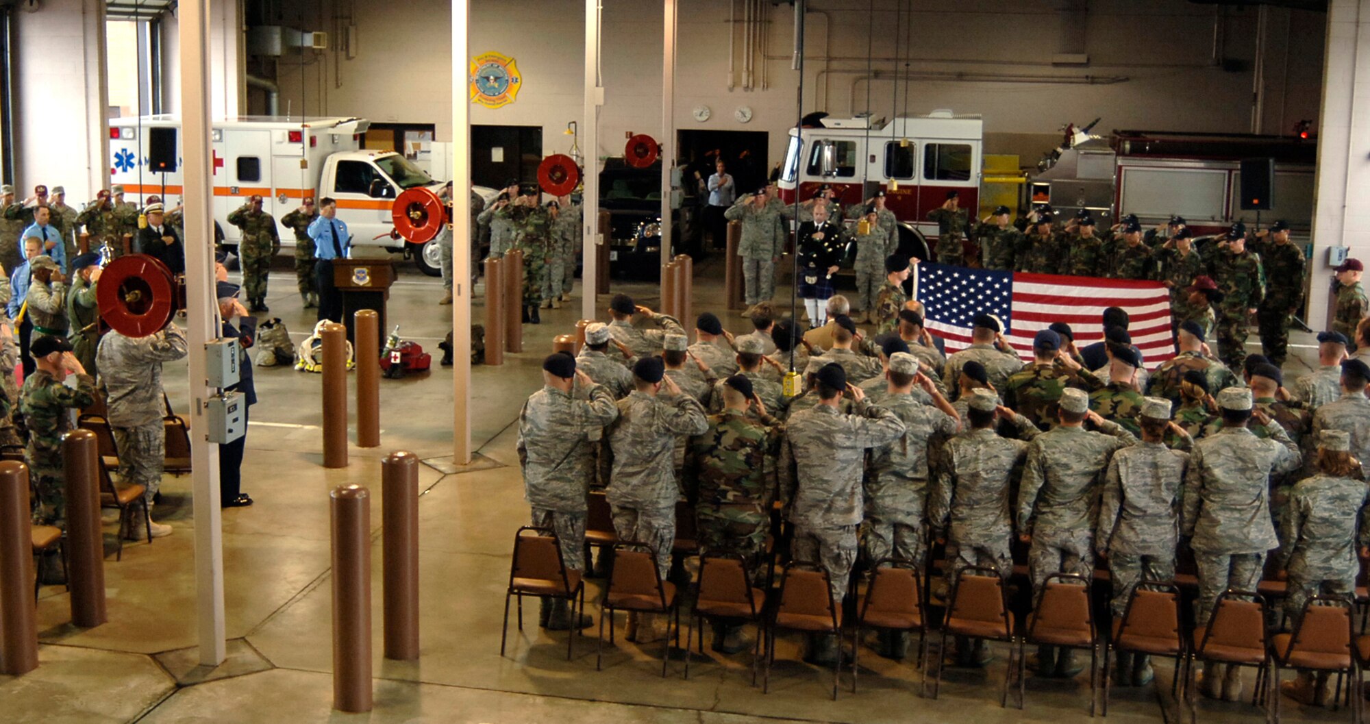 MCCONNELL AIR FORCE BASE, Kan. -- Airmen from the fire department, security forces squadron and medical group render a salute to the U.S. flag alongside Sedgwick County first responders participating in a Patriot Day Ceremony here, Sept.  11.  The ceremony is designated on this day to remember those who lost their lives during the Sept. 11 2001 terrorist attacks. (Photo by Airman 1st Class Maria Ruiz)