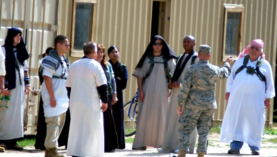 Tech. Sgt. Clinton Ackerly (center in uniform), from the U.S. Air Force Expeditionary Center's 421st Combat Training Squadron, gives instruction to role players for Air Force Exercise Eagle Flag 08-6 at Naval Air Engineering Station Lakehurst, N.J., Sept. 17, 2008.  The role players are critical players in the exercise playing roles as local villagers.  The exercise, managed by the Center's 421st CTS, tests and trains more than 400 Airmen in expeditionary combat support skills.  (U.S. Air Force Photo/Tech. Sgt. Scott T. Sturkol)