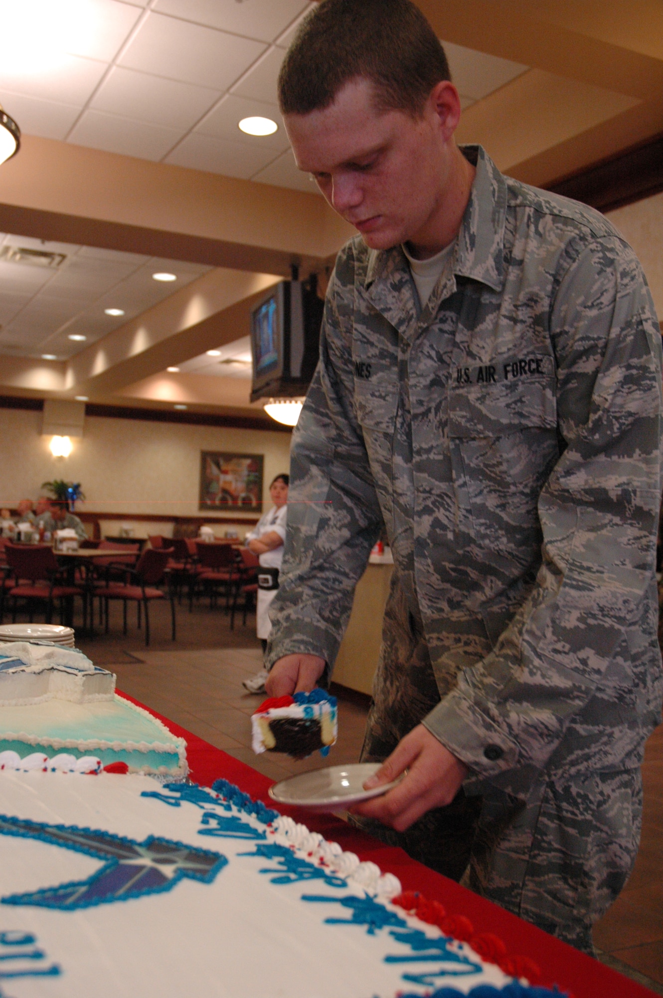 EGLIN AIR FORCE BASE, Fla. -- Airman Basic Kaleb Jones, Explosive Ordinance Disposal school students, a native of Waycross, Ga. cuts the first slice out of the cake celebrating the Air Force's 61st birthday April 29. 