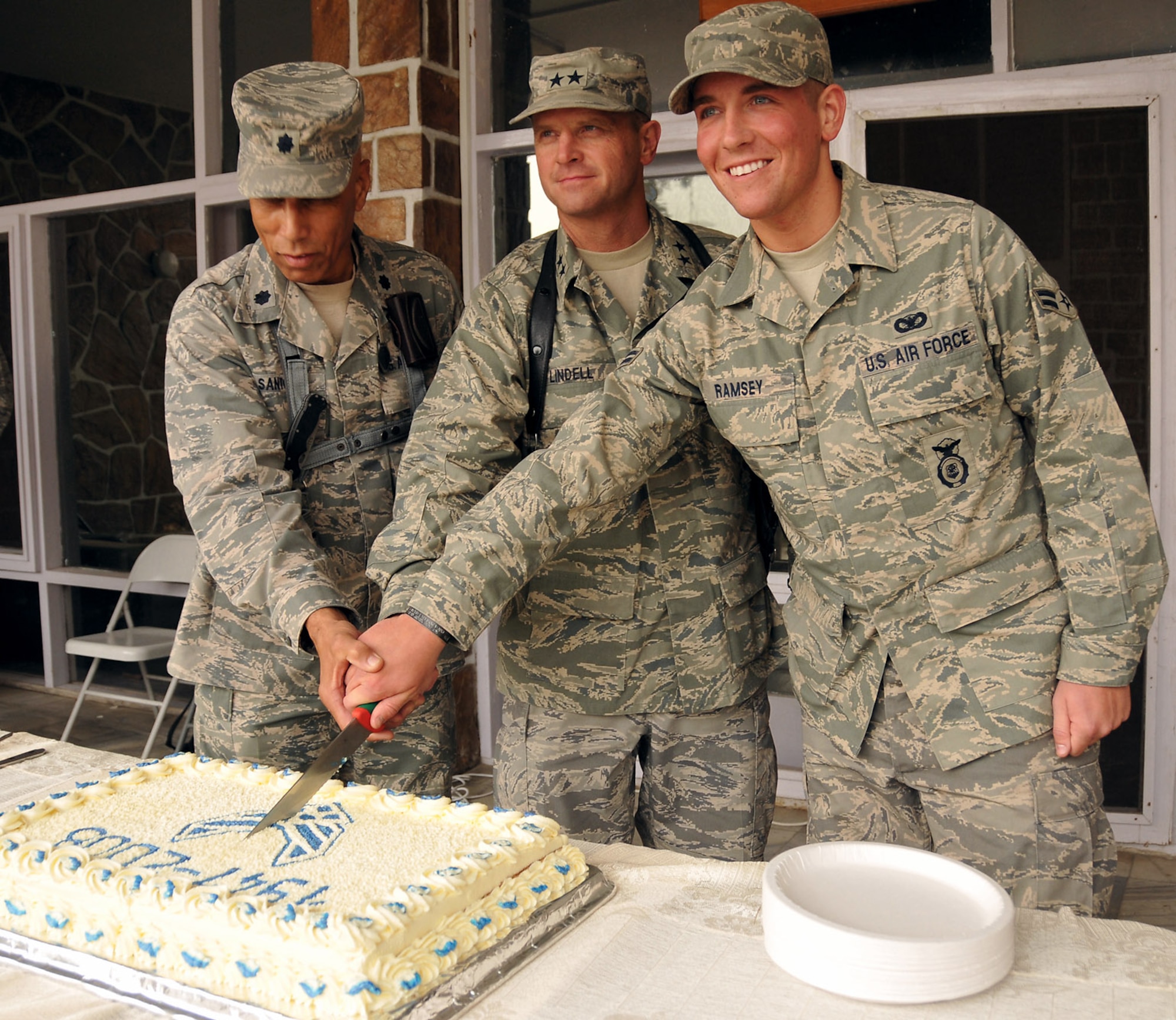 Lt. Col. Mathies Santos (from left to right), Maj. Gen. Jay H. Lindell and Airman 1st Class Jordan Ramsey cut the traditional birthday cake during a ceremony for the Air Force's 61st anniversary Sept. 18 at Kabul, Afghanistan. Colonel Santos is a Reserve Airman deployed from Quonset Point, R.I., General Lindell is the Combined Air Power Transition Force commanding general, and Airman Ramsey is a security forces airman deployed from Eglin Air Force Base, Fla. (U.S. Air Force photo/Staff Sgt. Beth Del Vecchio)