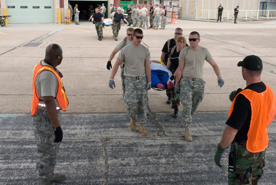 U. S. Air Force unit members from the 136th Airlift Wing, Texas Air National Guard, Fort Worth carry a special needs person awaiting to airlift to safety at the SE Texas Regional Airport, Beaumont , Texas, in support of Hurricane Ike relief efforts, 11 September 2008. (Photo by Staff Sgt Jennifer Marrs)