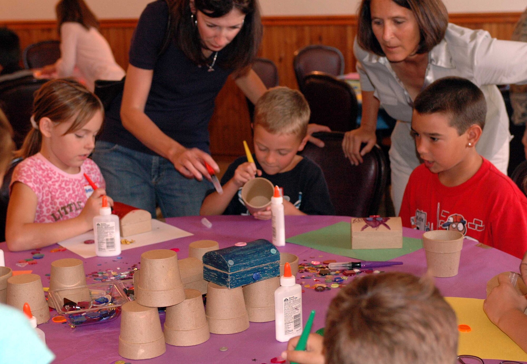 Children work on arts and crafts during the Deployed Spouses Dinner Sept. 16 at the Travis Conference Center. The event gives the spouses and children of those deployed a chance to socialize with other families, hear from base leadership and learn how the military community can assist them while their spouse is deployed. (U.S. Air Force photo/Airman 1st Class Kristen Rohrer)
