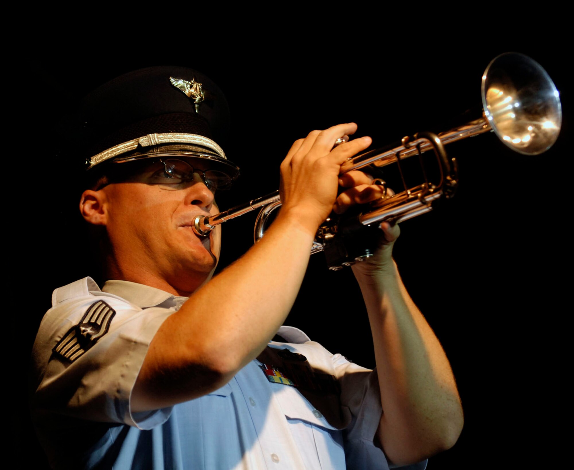 LANGLEY AIR FORCE BASE, Va.-- A member of the Air Combat Command Heritage of America Band plays a solo during the Air Combat Command Tattoo ceremony Sept. 11. The Tattoo was a mixture of music, lights and fireworks honoring the nation's military, past and present. (U.S. Air Force photo/Airman Rebecca Montez)
