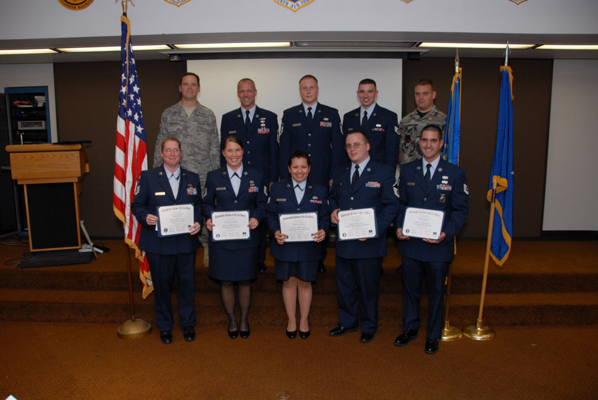 Flying Yankees from the 103rd Airlift Wing smile for a group photo after receiving Community College of the Air Force degrees at a graduation ceremony June 28, 2008 at the Connecticut Air National Guard Base, East Granby, Conn.  (U.S. Air Force Photo by Staff Sgt. Nicholas A. McCorkle)