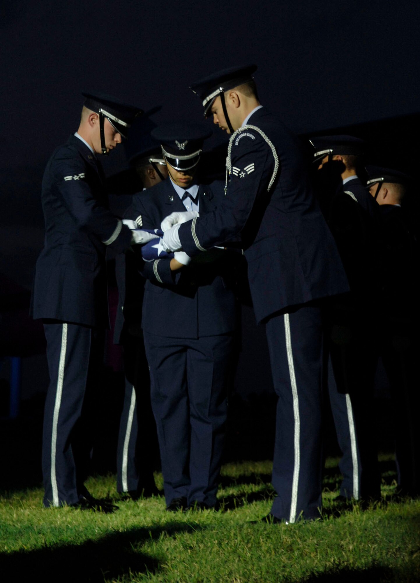 LANGLEY AIR FORCE BASE, Va.-- The Langley Honor Guard folds the flag during the Air Combat Command Tattoo ceremony Sept. 11. The Tattoo was a mixture of music, lights and fireworks honoring the nation's military, past and present. (U.S. Air Force photo/Airman Rebecca Montez)