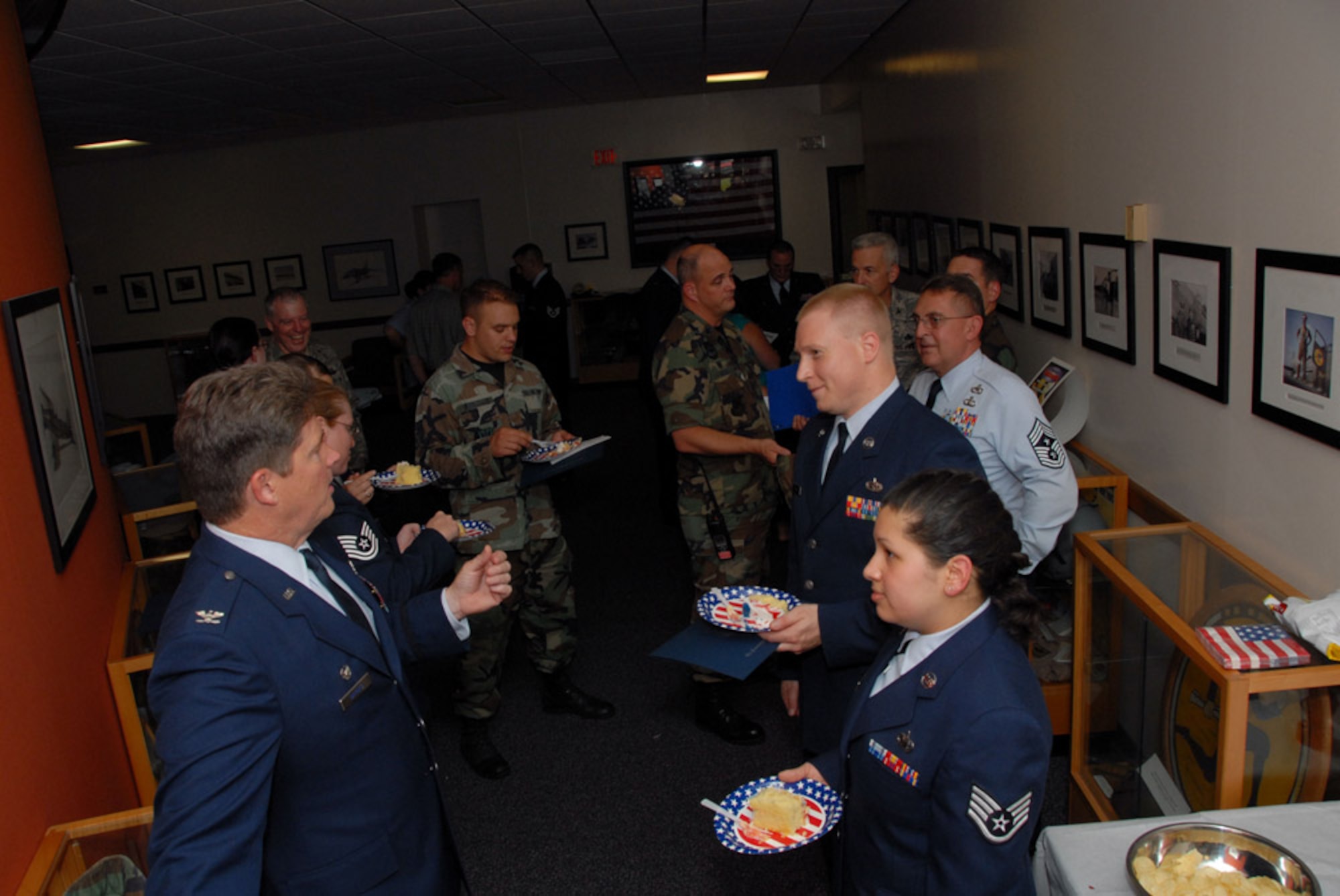Col. Brian P. Barnes, commander, 103rd Airlift Wing, (left) chats with Community College of the Air Force graduates at a reception following the graduation ceremony at the Connecticut Air National Guard Base, East Granby, Conn. on June 28, 2008.  Col. Barnes was the guest speaker for the event and awarded the CCAF degrees to the graduates.  (U.S. Air Force Photo by Staff Sgt. Nicholas A. McCorkle)