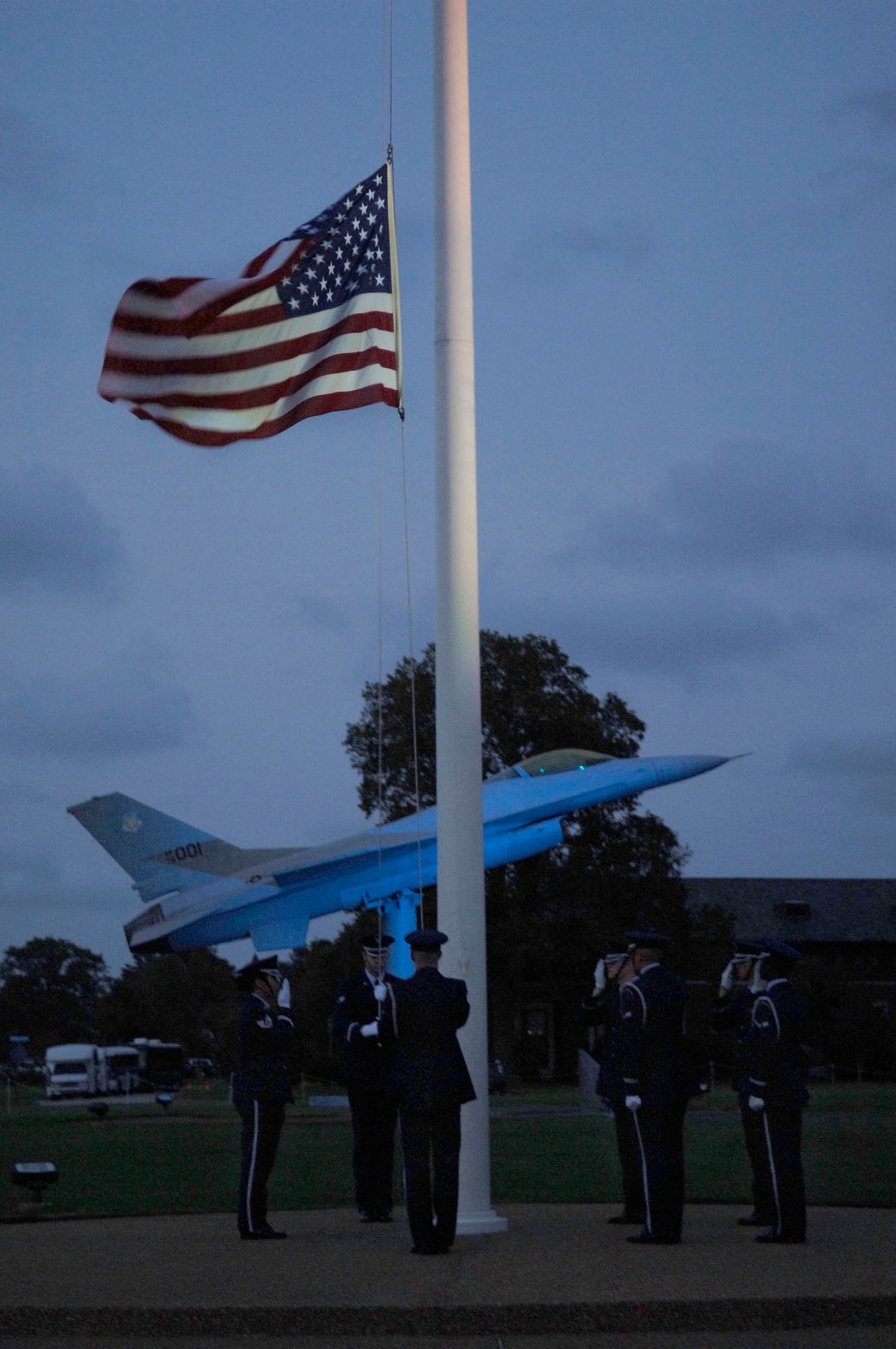 LANGLEY AIR FORCE BASE, Va.-- The Langley Honor Guard lowers the flag during the Air Combat Command Tattoo ceremony Sept. 11. The Tattoo was a mixture of music, lights and fireworks honoring the nation's military, past and present. (U.S. Air Force photo/Airman Rebecca Montez)