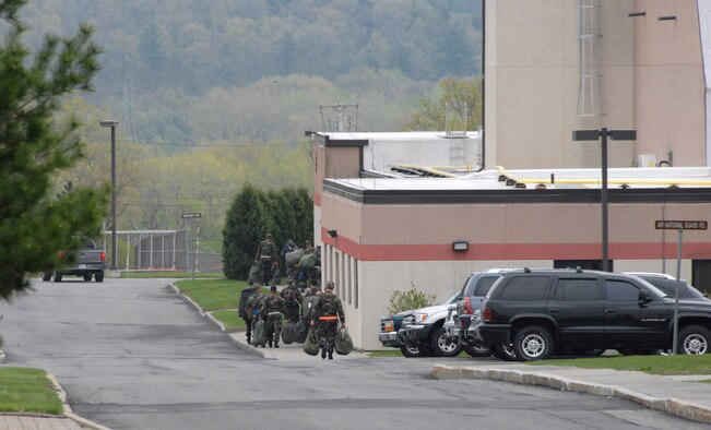 Airmen carry their gear after going through the mobility line during an exercise in May. The base was evaluated on how well it responded to a deployment tasking.